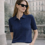 Woman wearing navy blue short sleeve knit polo shirt outdoors, elegant casual style