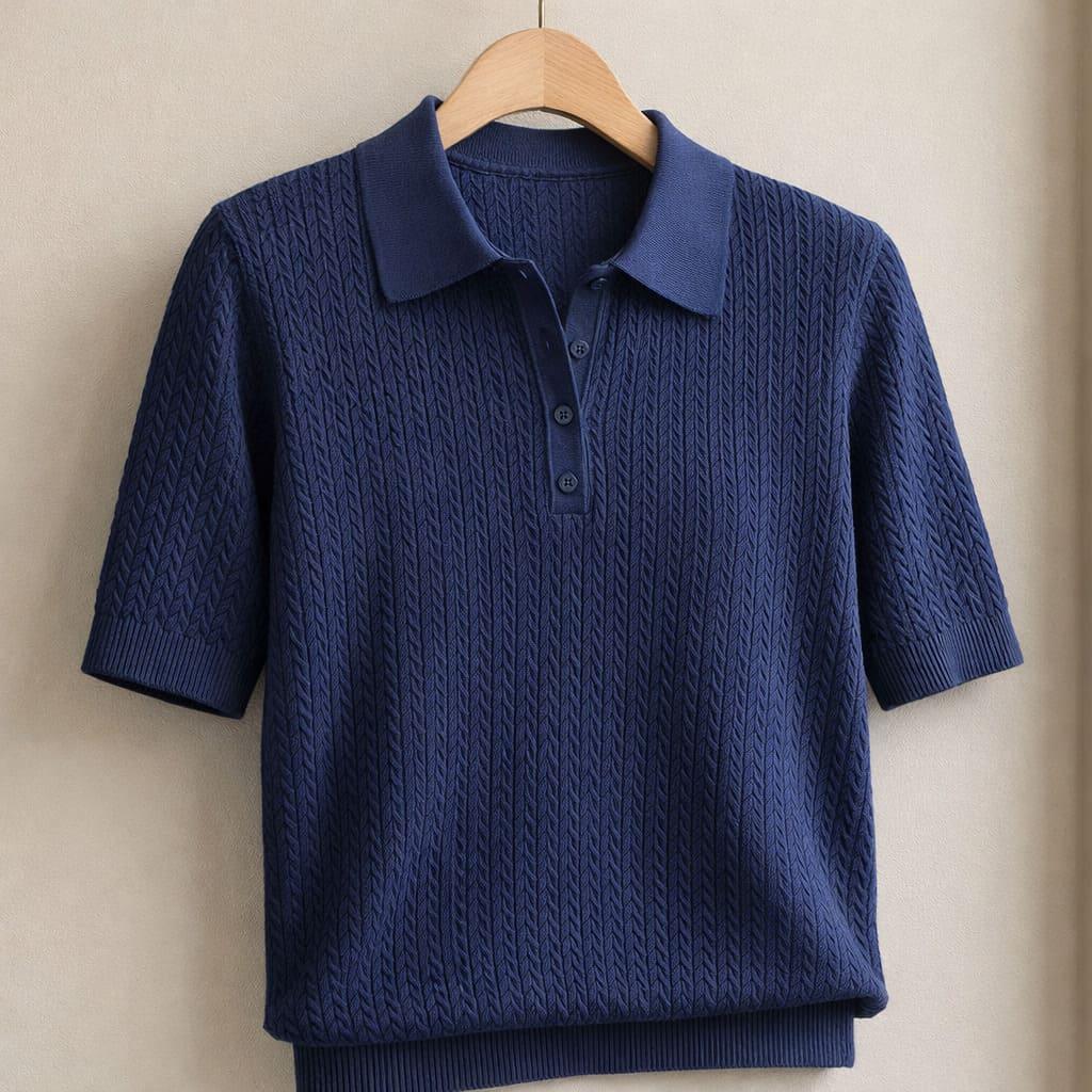 Navy textured knit polo shirt with short sleeves and collar on a wooden hanger