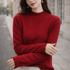 Woman wearing a red high-neck jumper sweater outdoors, casual winter fashion