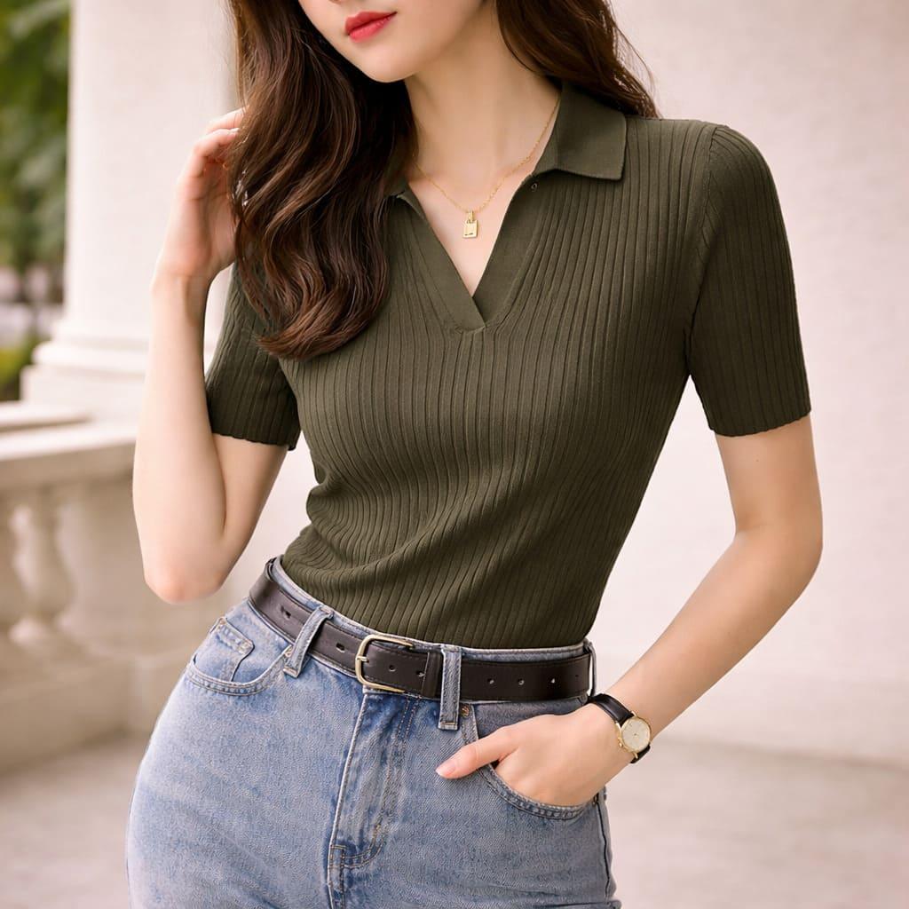 Woman wearing olive ribbed knit polo shirt with V-neck and short sleeves, paired with jeans