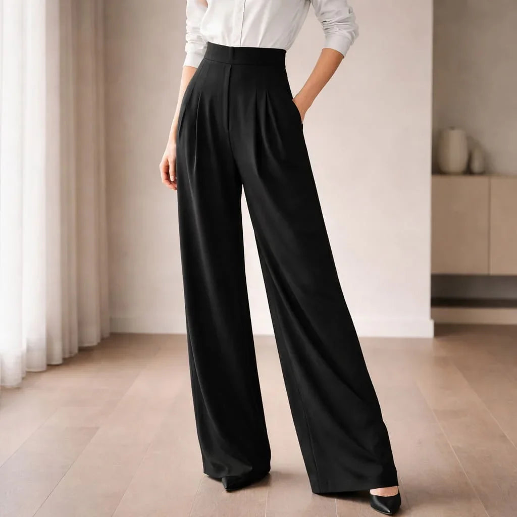 High-waisted black tailored wide-leg trousers styled with a white blouse