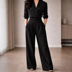 Woman wearing high-waisted black wide-leg tailored trousers indoors