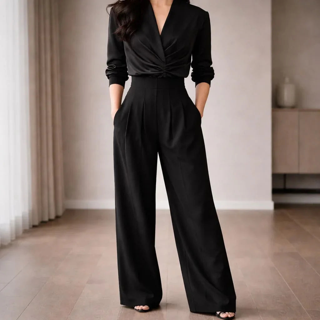 Woman wearing high-waisted black wide-leg tailored trousers indoors