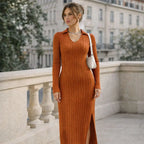 Woman wearing a ribbed orange V-neck long-sleeve dress with slit, standing outdoors
